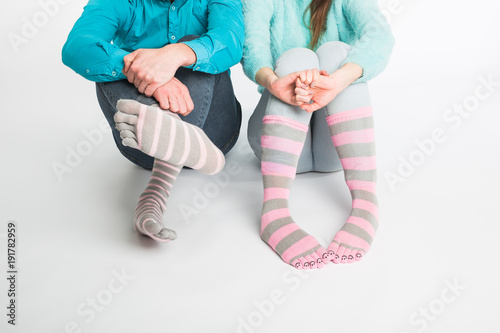 Valentine's day concept - Male and female legs in socks. photo