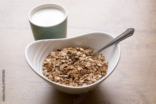 healthy breakfest on wooden table, oatmeal with milk