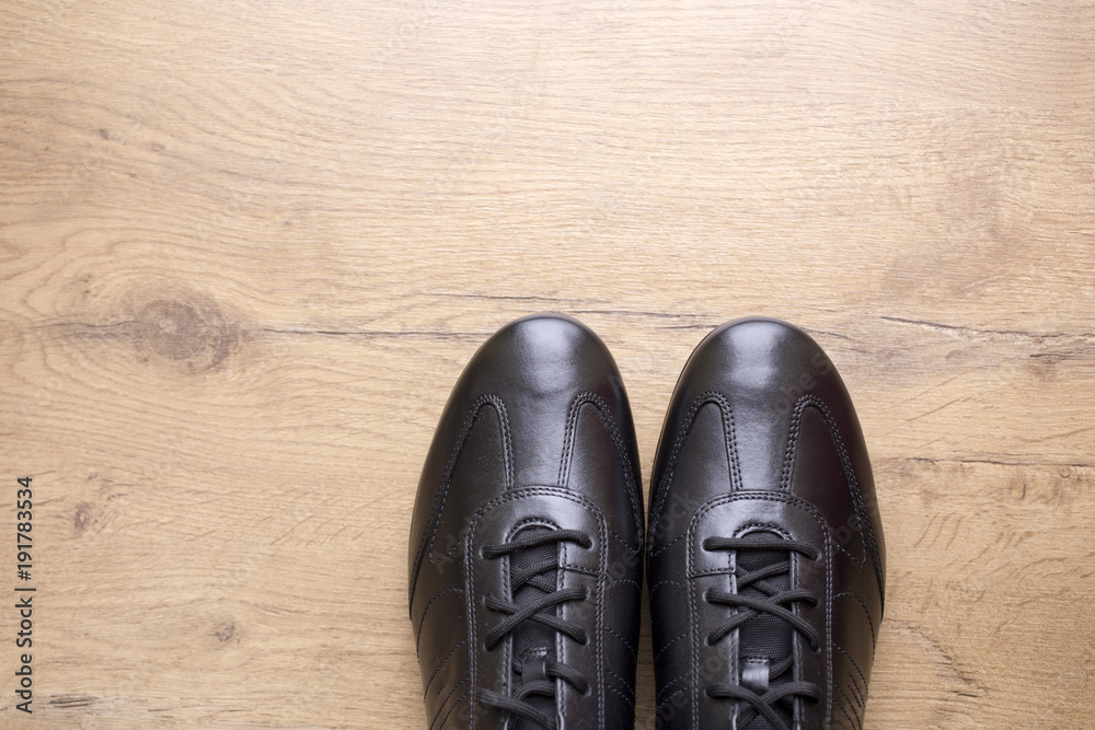 Black leather men shoes on wooden background Black leather men shoes on wooden background