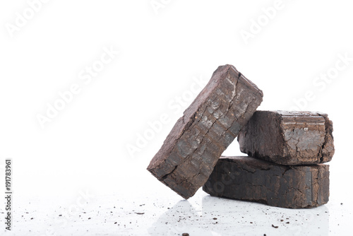Bild auf Leinwand Peat briquettes on white background, alternative fuels, space for text