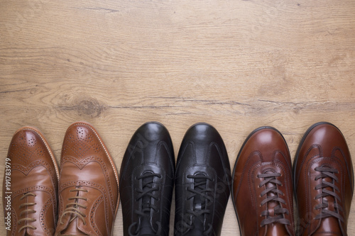 Stylish men leather shoes on wooden background