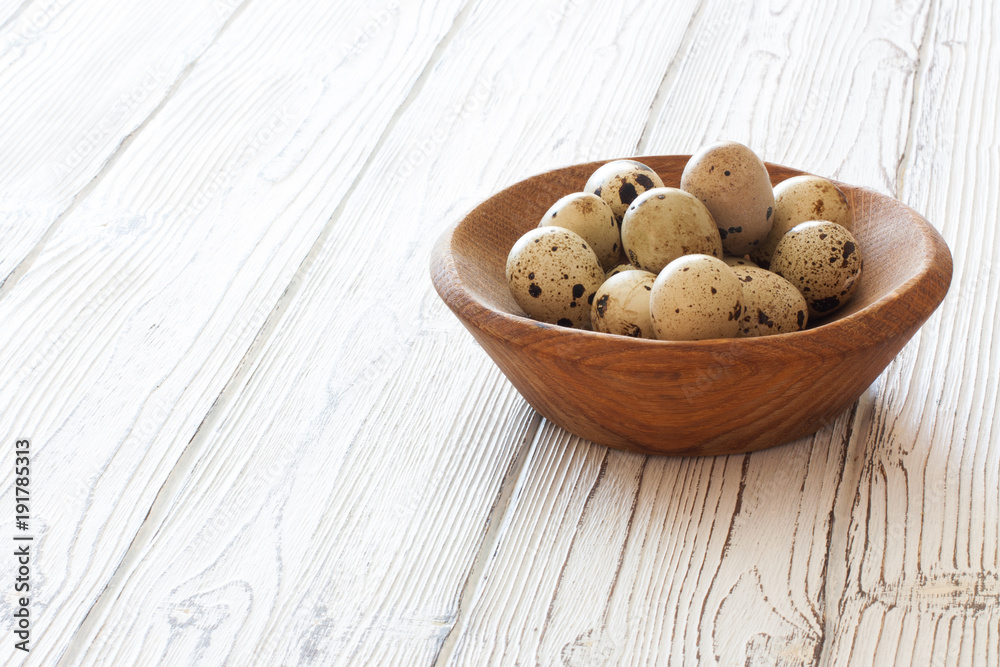 Quail eggs in a wood bowl Quail eggs in a wood bowl