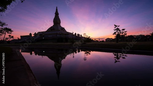 Time lapse of a sacred Buddhist monument with beautiful sky at dawn, Roi Et province, Thailand photo