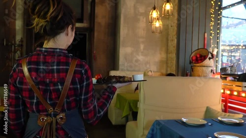 The waitress brings the order to the customer on the tray