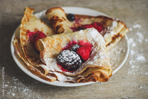 Pancakes with berries and sweet jam photo