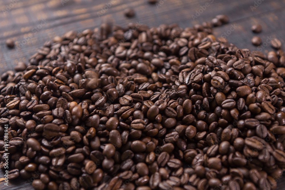 roasted coffee beans on dark wooden table roasted coffee beans on dark wooden table