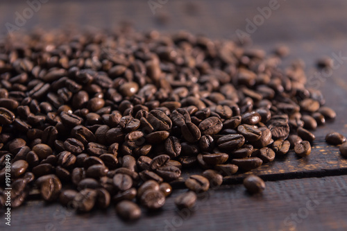 roasted coffee beans on dark wooden table