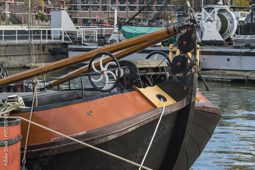 Old harbor featuring details of vintage freight ships in Rotterdam, Netherlands.