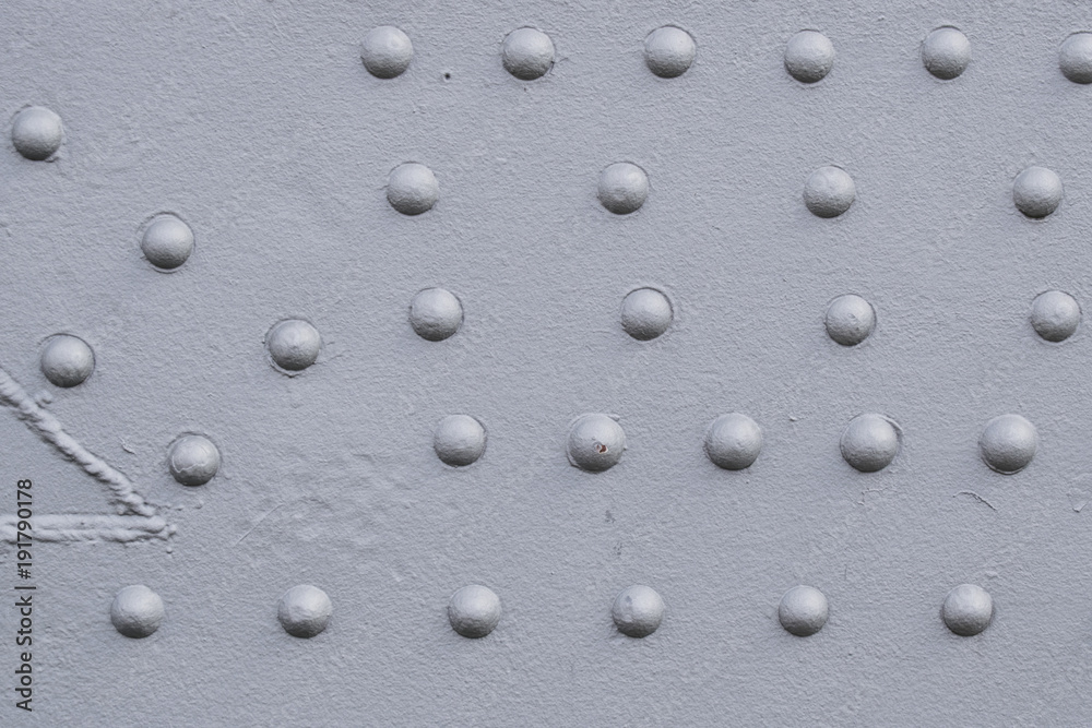 Detail of old sea port crane frame. Steel painted background with rivets illustrating industry and construction concepts.