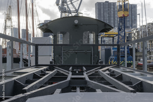 Dark industrial background with seaport cranes, locomotive an freight carriage in old harbor of Rotterdam, Netherlands.