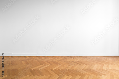 wooden parquet floor and white wall background   photo