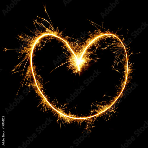 Sparkling golden heart isolated on black background