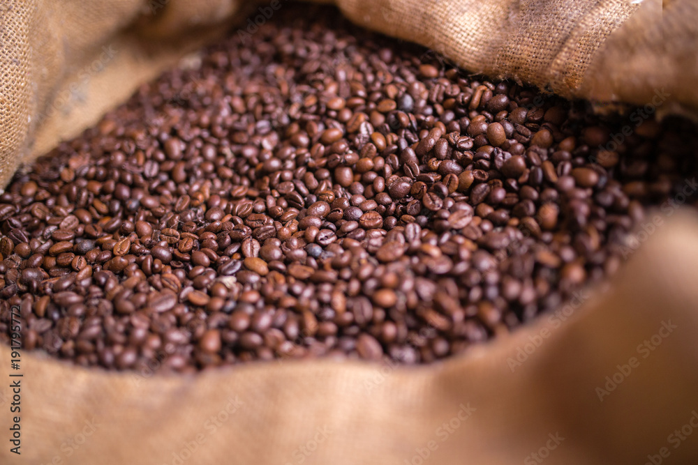 A burlap bag with coffee beans inside A burlap bag with coffee beans inside