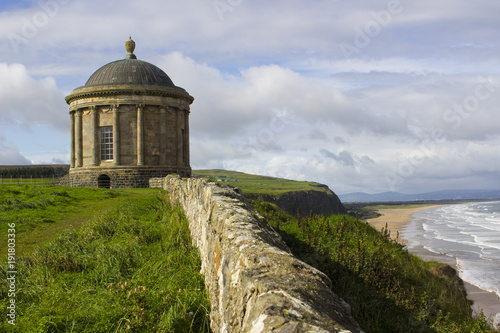 The ancient Mussendun Temple Monument on the clifftop edge overlooking Downhill Beach in County Londonderry Ireland photo