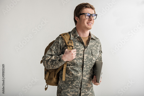 Valokuva Happy male cadet holding laptop and smiling