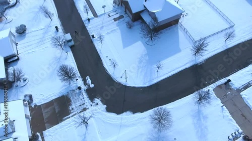 4k Aerial view of United States Postal Service delivering mail on a cold snowy winter day