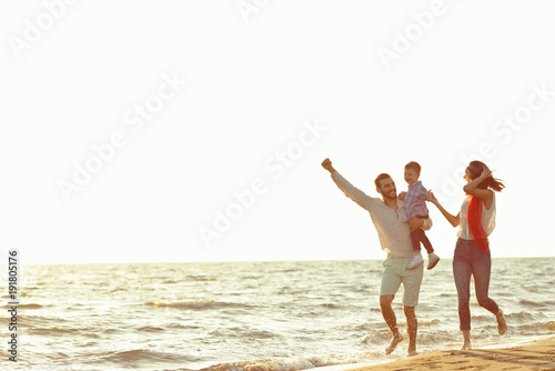 portrait of happy family and baby enjoying sunset in the summer leisure