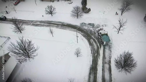 4k Aerial view of City snow plow truck removing snow from residential streets, Chicago South suburbs