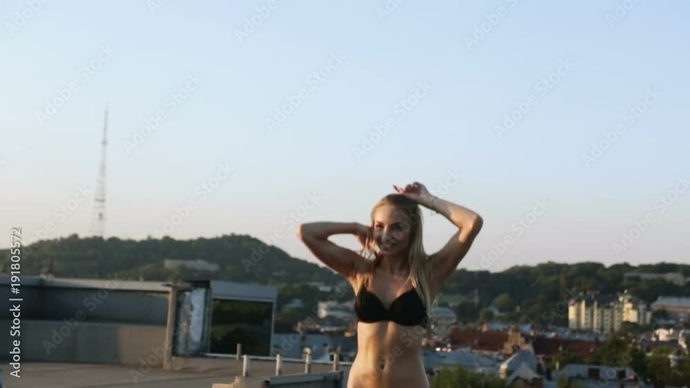 pretty nice blonde woman swimming suit jumping trampoline roof urban landscape background portrait full view sun light summer sunshine sport activity leisure leap recreation cardio gym fut fashion pretty nice blonde woman swimming suit jumping trampoline roof urban landscape background portrait full view sun light summer sunshine sport activity leisure leap recreation cardio gym fut fashion