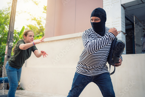 Slika na platnu Robber snatching money and bag from women on the street, Thief, Robbery concepts