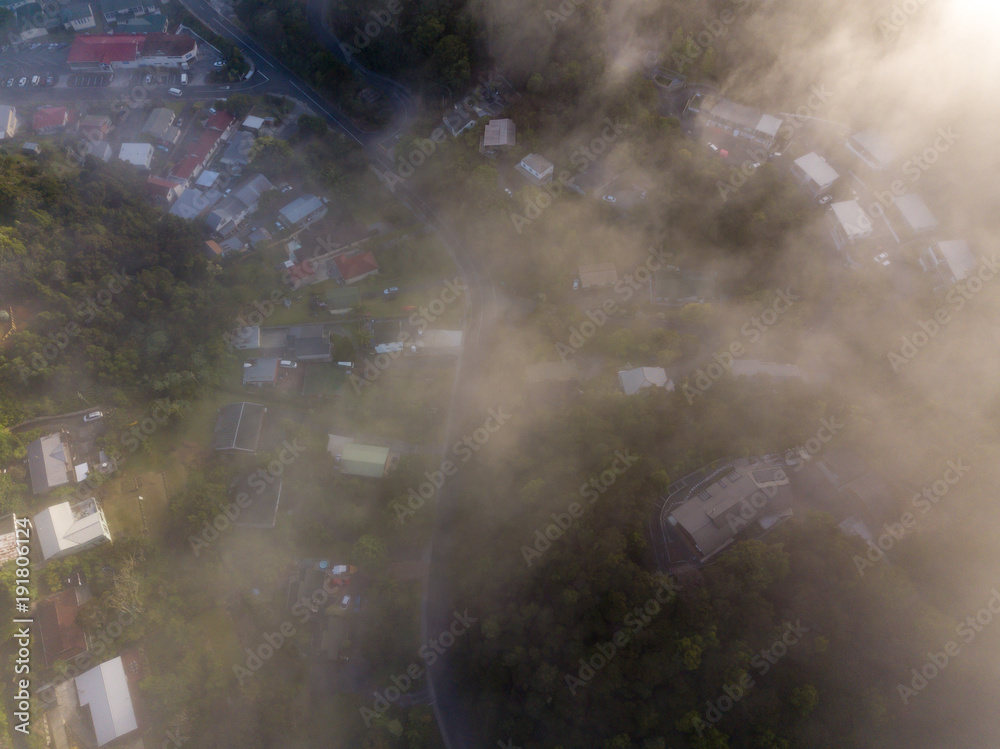 Naklejka premium Top Down View Of Fog Covered New Zealand Town 