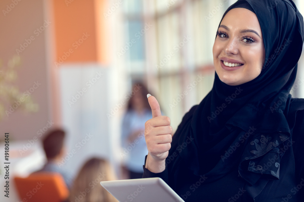 Pretty woman wearing hijab in front of laptop search and doing office work, business, finance and workstation concept. Pretty woman wearing hijab in front of laptop search and doing office work, business, finance and workstation concept.