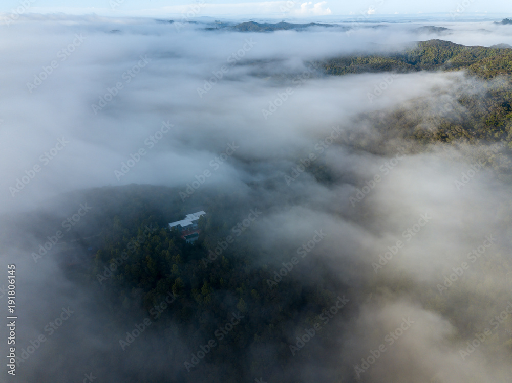 Low Flying Clouds Cover Mountains And Homes In New Zealand in Morning Low Flying Clouds Cover Mountains And Homes In New Zealand in Morning