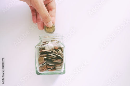 Hand saving a coin into the...