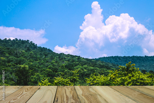 Blue sky witBeautiful golden grassland in Thailand with wooden floor space.h beautiful clouds. photo