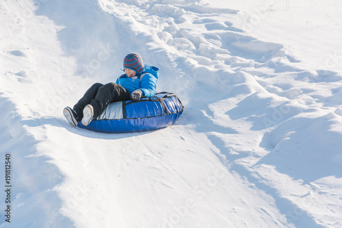 Children ride on tubing. Winter entertainment. Skiing in the winter. Snowy fun in the winter. Fun in the winter. Tubing.