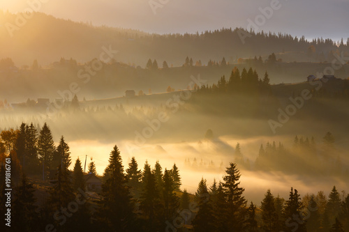 First sunrise rays of sun in Carpathian mountains.