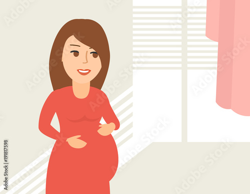 beautiful pregnant woman near the window