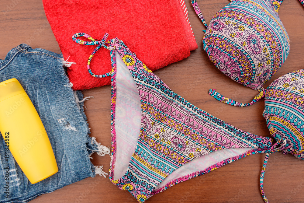 Fototapeta premium Set of beachwear on wooden background