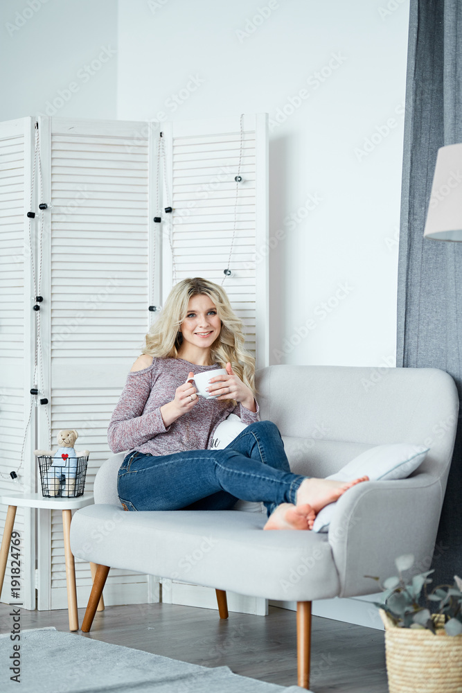 Young blonde beautiful lady drinking tea at home Young blonde beautiful lady drinking tea at home