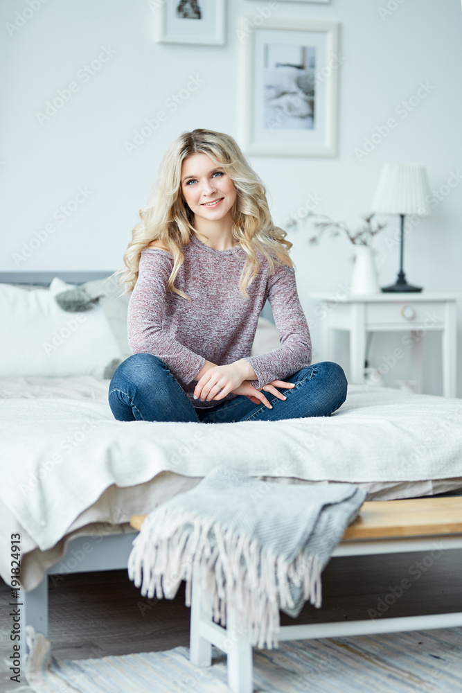 Attractive young blond woman relaxing in sofa Attractive young blond woman relaxing in sofa