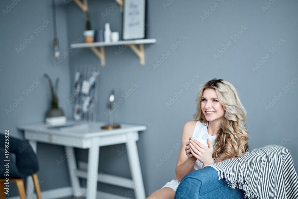 Young blonde beautiful lady drinking tea at home Young blonde beautiful lady drinking tea at home