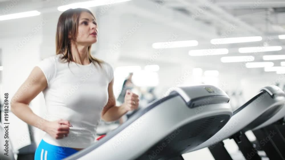 sexy woman running on sole treadmill in the gym sexy woman running on sole treadmill in the gym