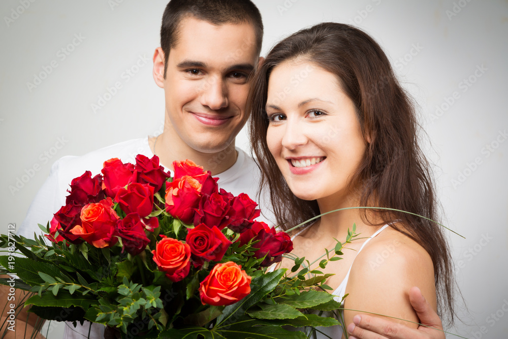Fototapeta Happy Valentine's Couple Holding Bouquet Of Roses