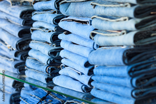 Closeup shot of stack of folded jeans in the fashion store