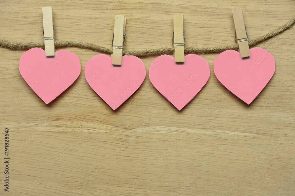 Pink Hearts are with wooden clamps and clamp. Hanging on wooden planks. Pink Hearts are with wooden clamps and clamp. Hanging on wooden planks.