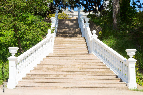 Outdoor staircase with white handrails