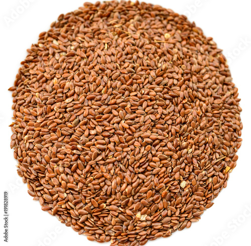 Closeup flax seeds on white background. Selective focus.