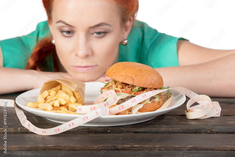 focus on hamburger with potatoes on background ginger girl close up focus on hamburger with potatoes on background ginger girl close up