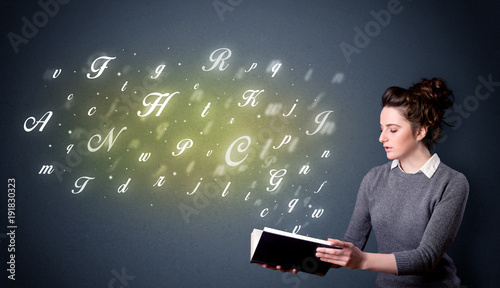 Young lady holding book with letters