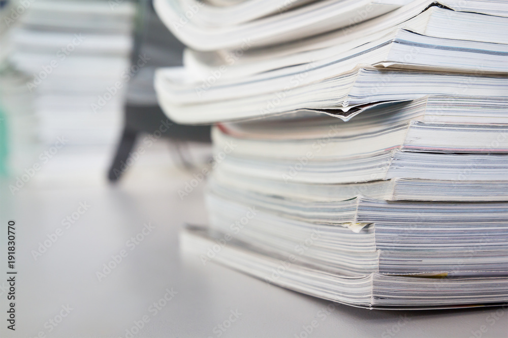 stacked magazine books on white table
