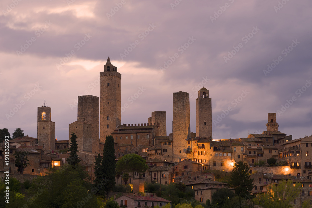 Towers of San Gimignano in the cloudy evening twilight. Tuscany, Italy