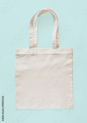 Tote bag canvas fabric cloth eco shopping sack mockup blank template isolated on pastel blue background (clipping path)