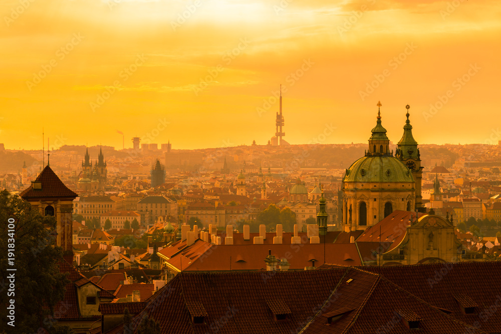 Sunset in Prague as seen from Prague castle, with rooftop view of the city and television tower