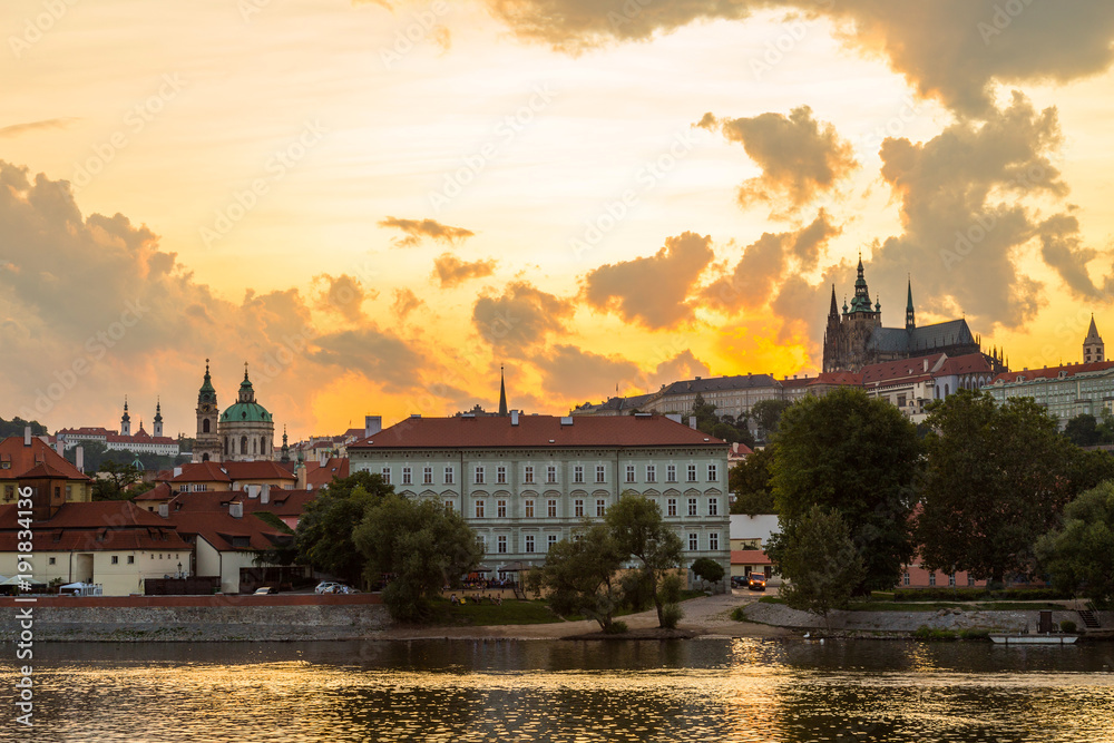 Sunset in Prague with Prague castle, Saint Vitus Cathedral, and the river Vltava.