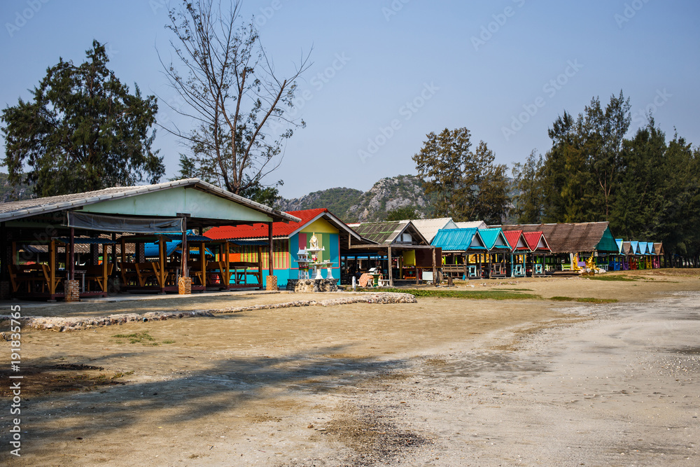 shops with bright roofs on the beach